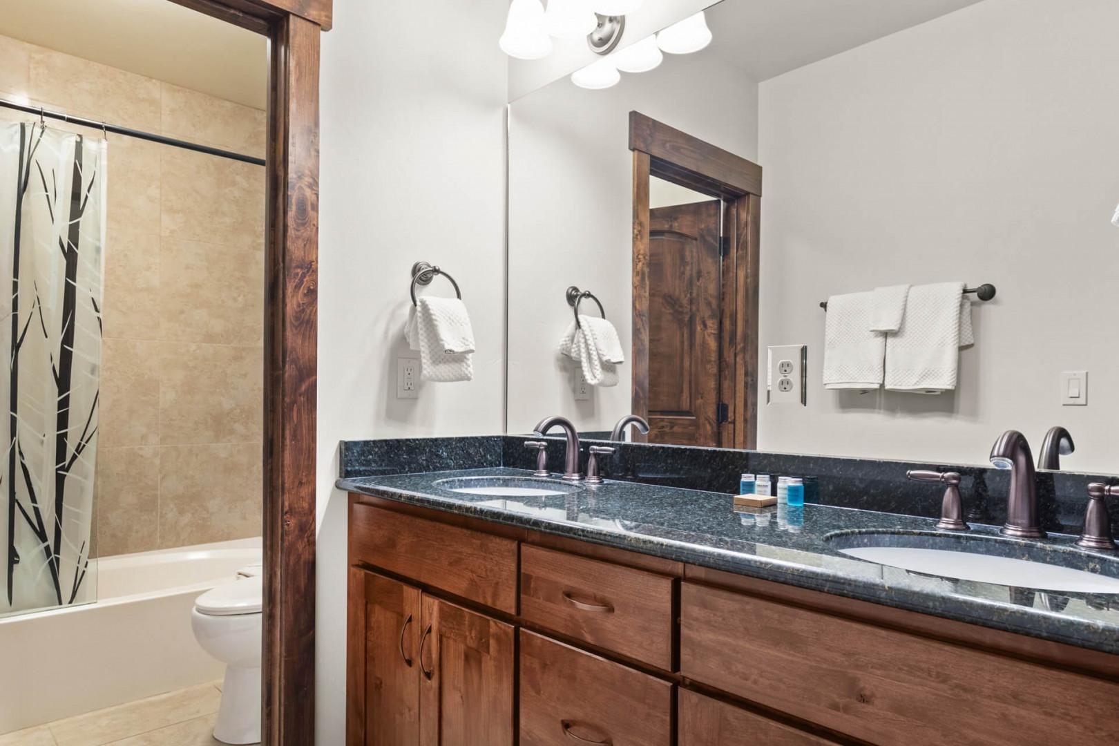 Your spacious bathroom features double vanities with granite countertops, perfect for getting ready together in the morning.