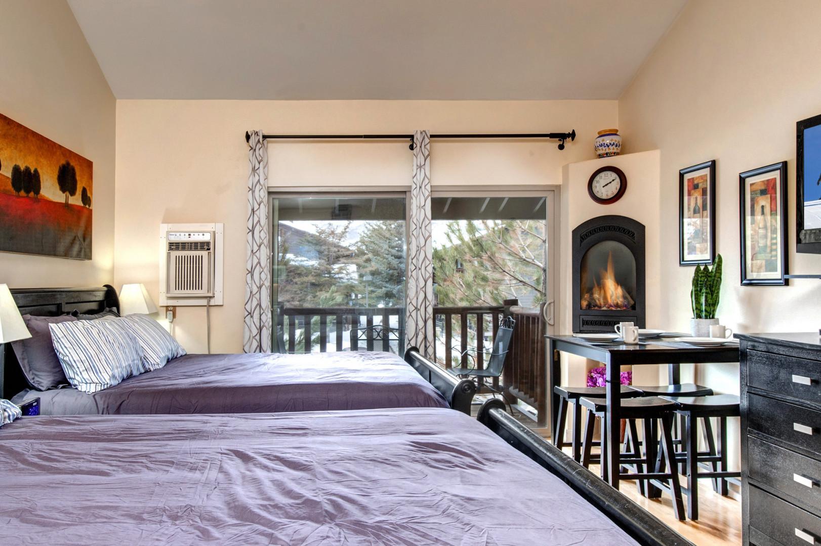 Two Queen Bed Suite: "Cozy setup with patio view, perfect for a relaxing staycation."