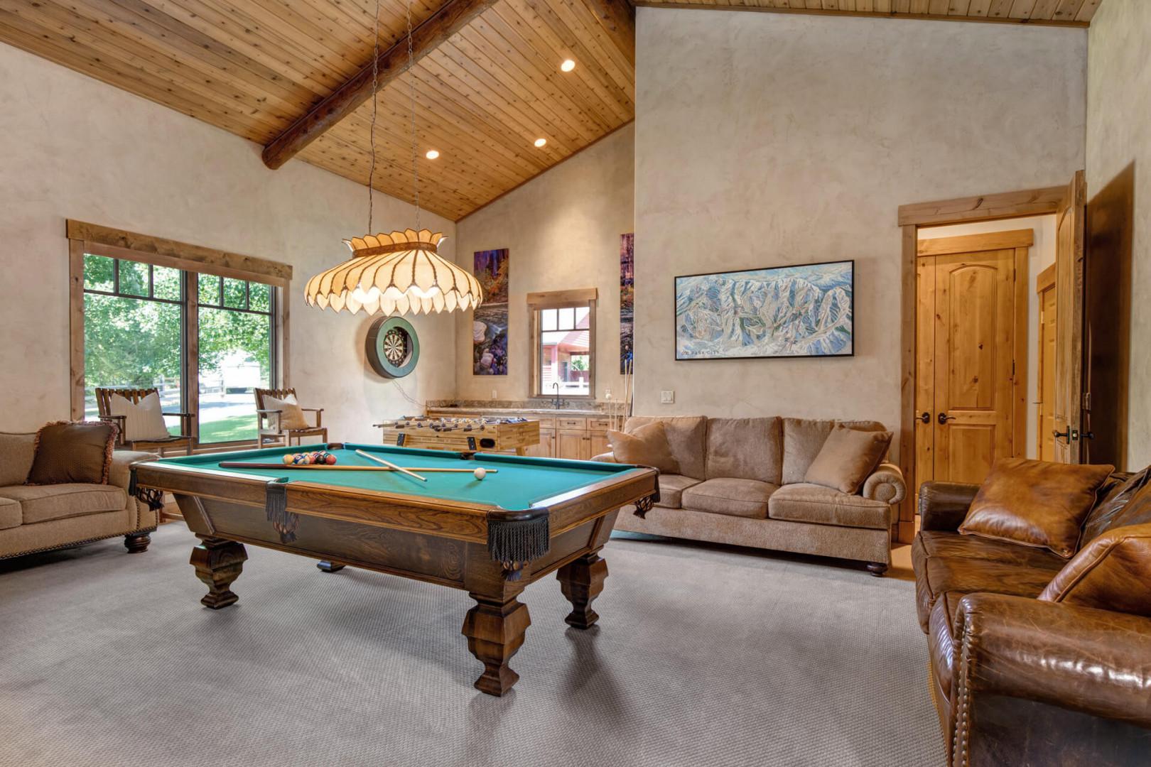 Cozy corner with table games and plush sofa set for relaxation.