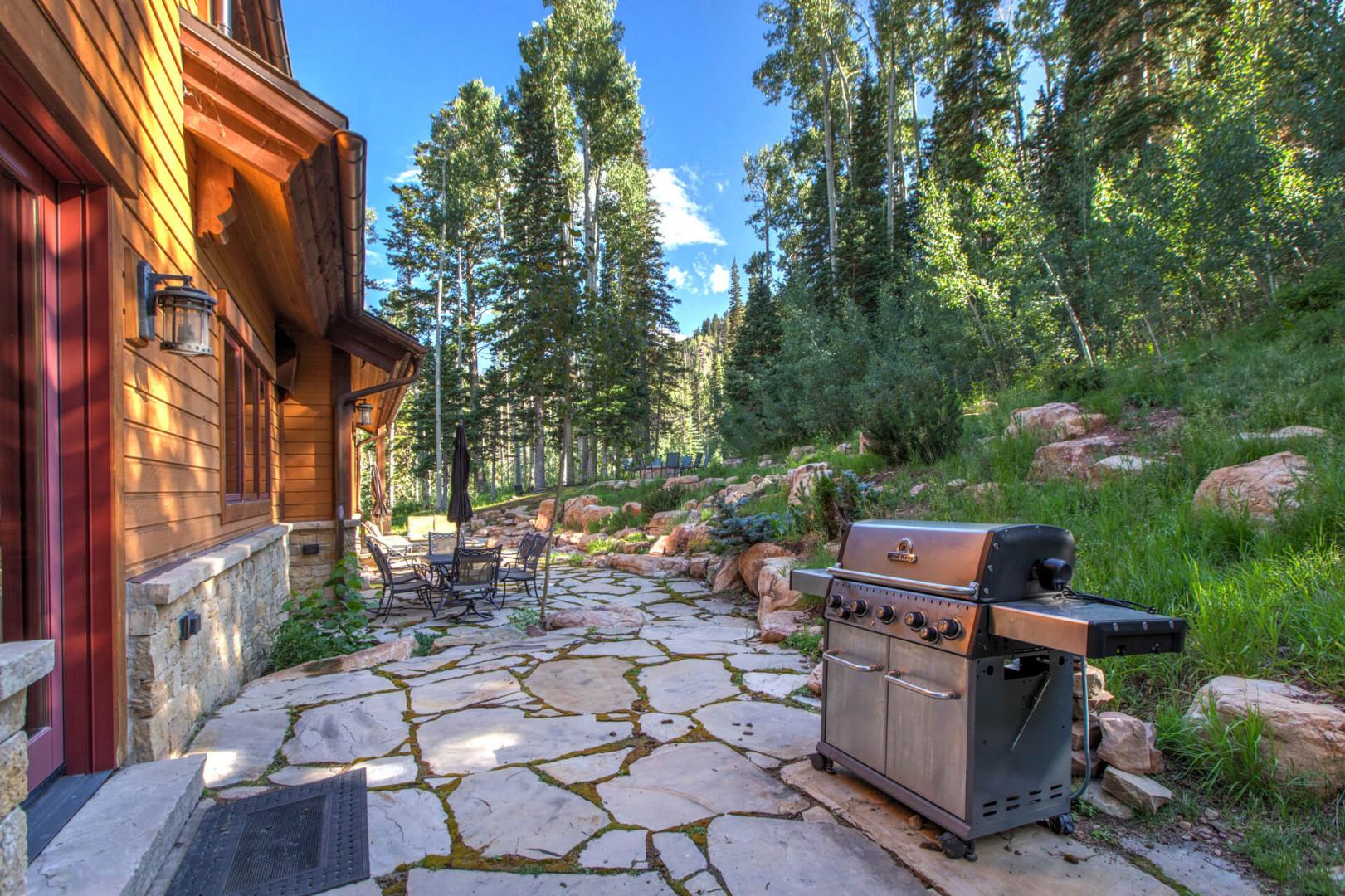 Alfresco dining awaits in this charming backyard oasis.