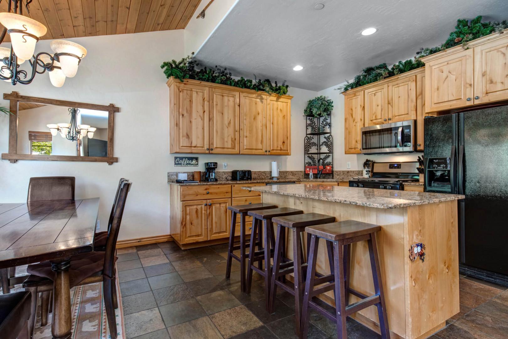 Bear Hollow Lodges 5474: Sleek kitchen setup with bar stools, appliances, and chic cabinets.