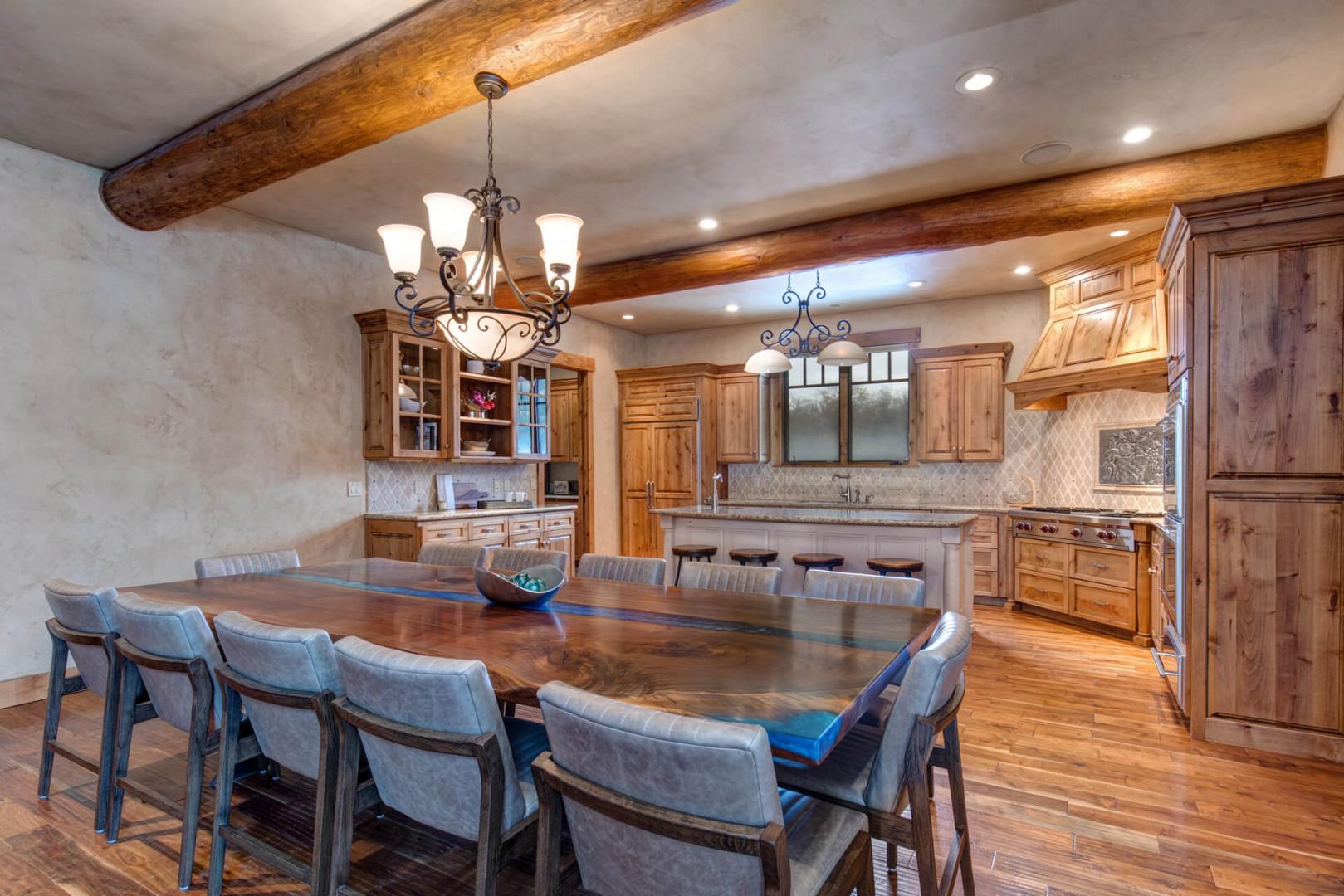 Dining table: "Inviting setting with a view of the kitchen area."