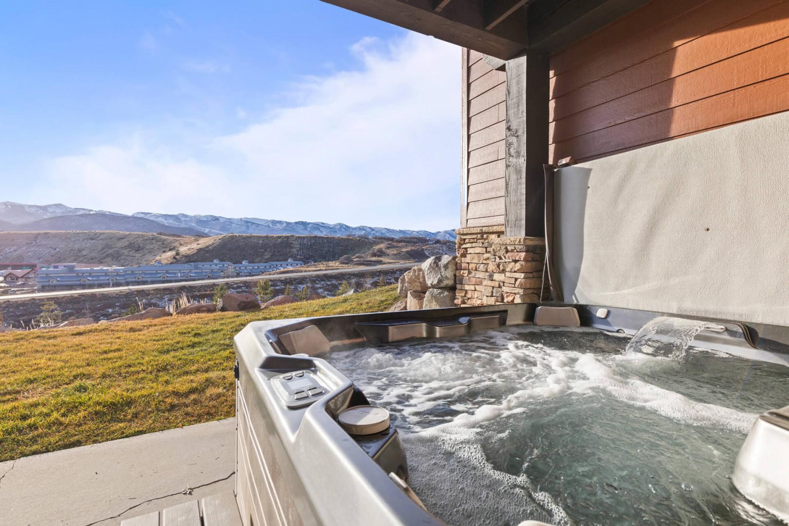 Soak in your private hot tub while gazing at stunning mountain views. Pure relaxation awaits on your covered patio.