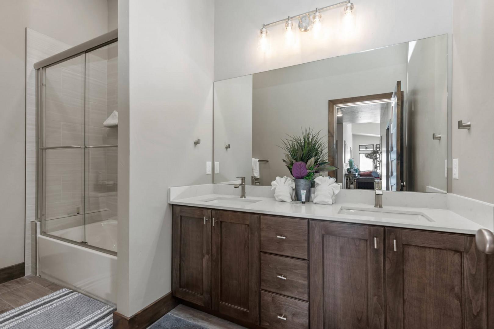 Modern sink and spacious shower area in this cozy room.