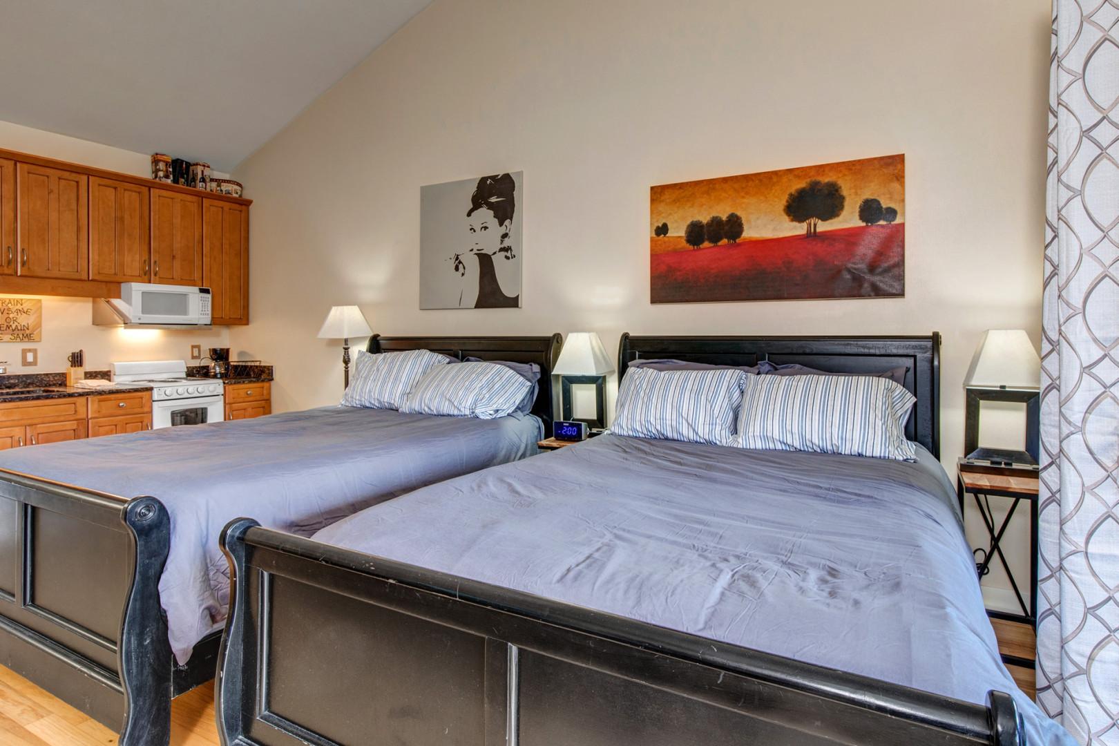 Two Queen Bed Suite: "Cozy setup with patio view, perfect for a relaxing staycation."