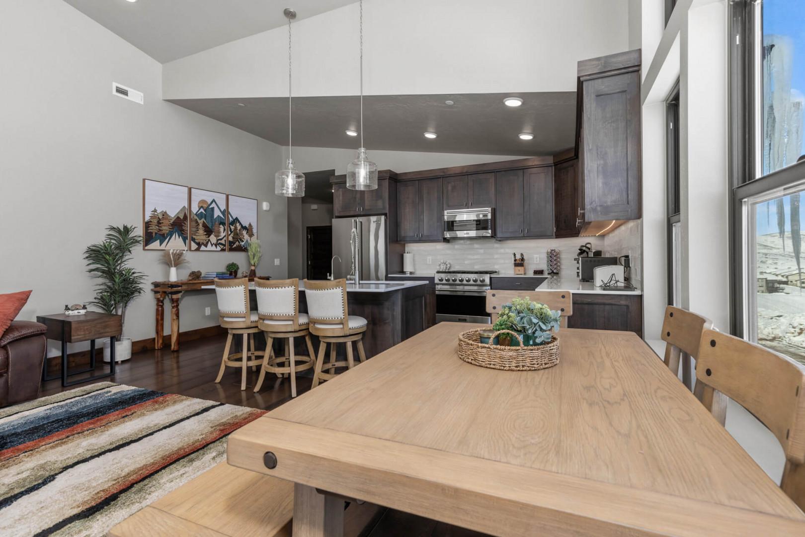 Cozy setup with bar stools and a well-equipped kitchen.