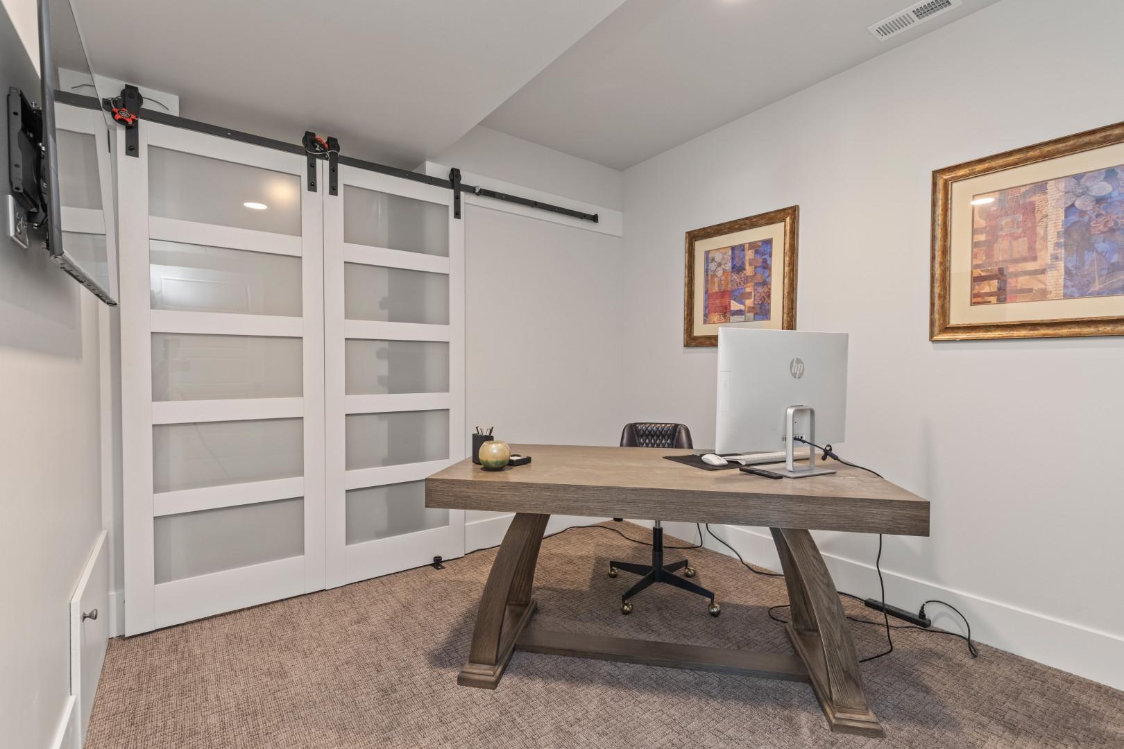 Deer Springs 12797: Home Office: "Minimalistic workspace with a desk, chair, and monitor setup."