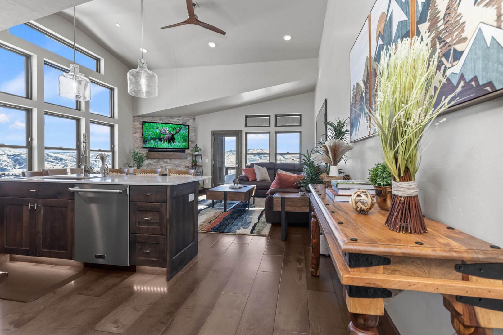 Sleek kitchen overlooking cozy sofa set, perfect for relaxing evenings.