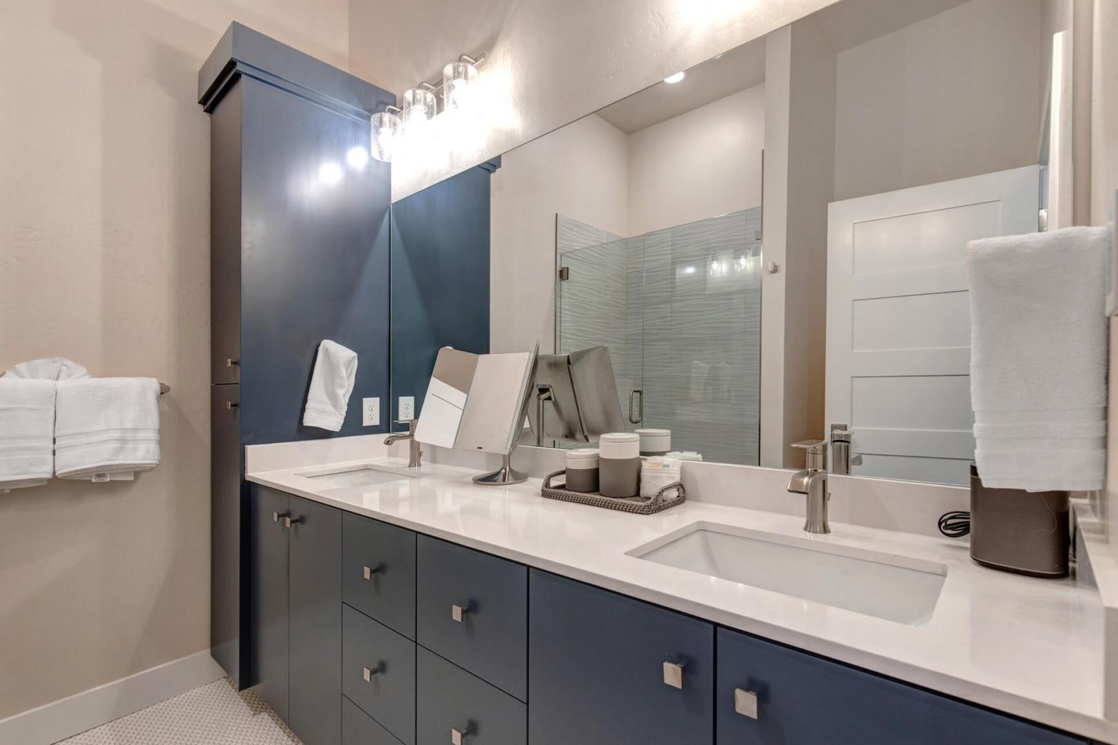 Reflective sink area with a sleek mirror, perfect for morning routines.