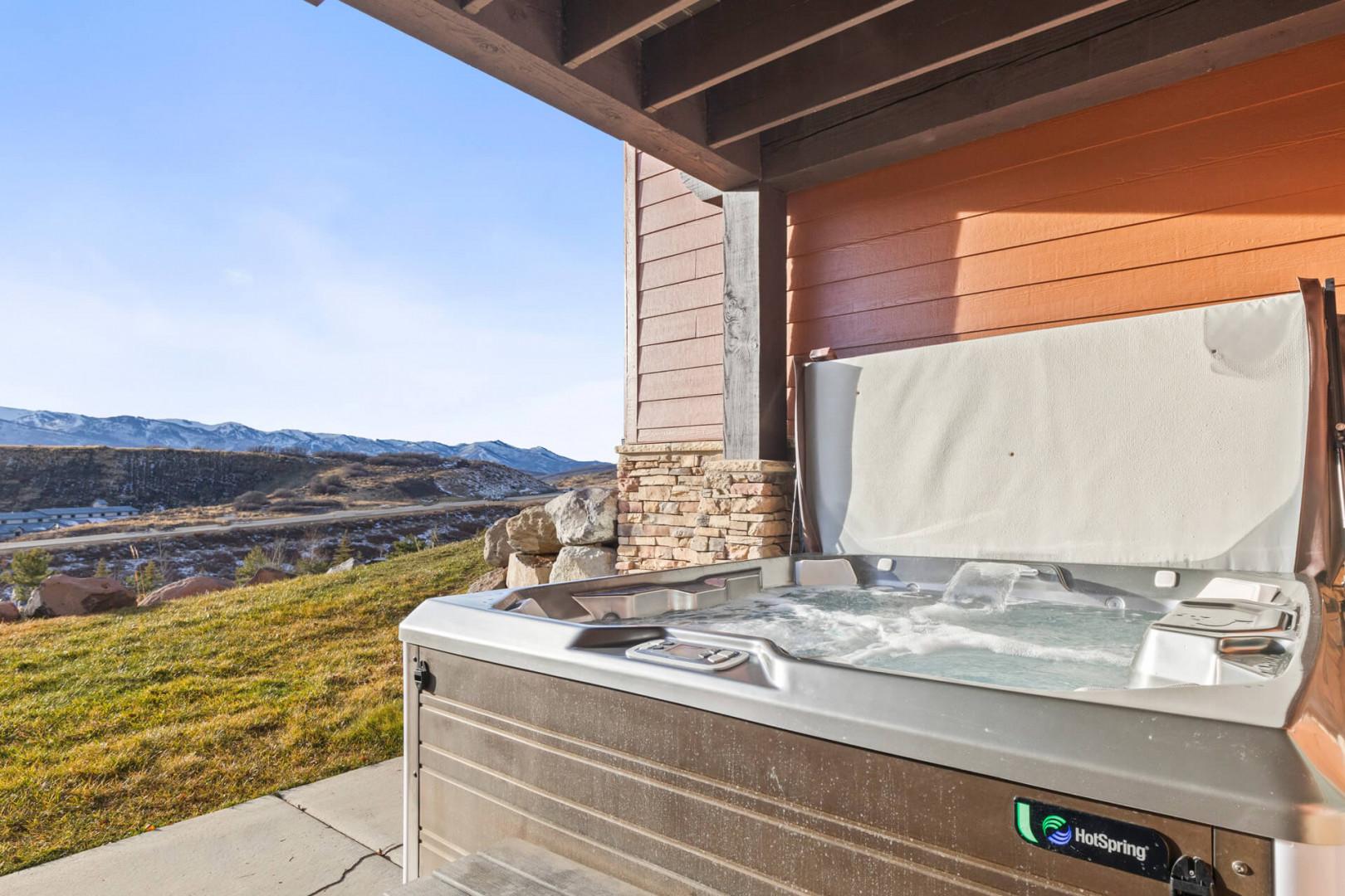 Soak in your private hot tub while taking in breathtaking mountain views from your covered patio.