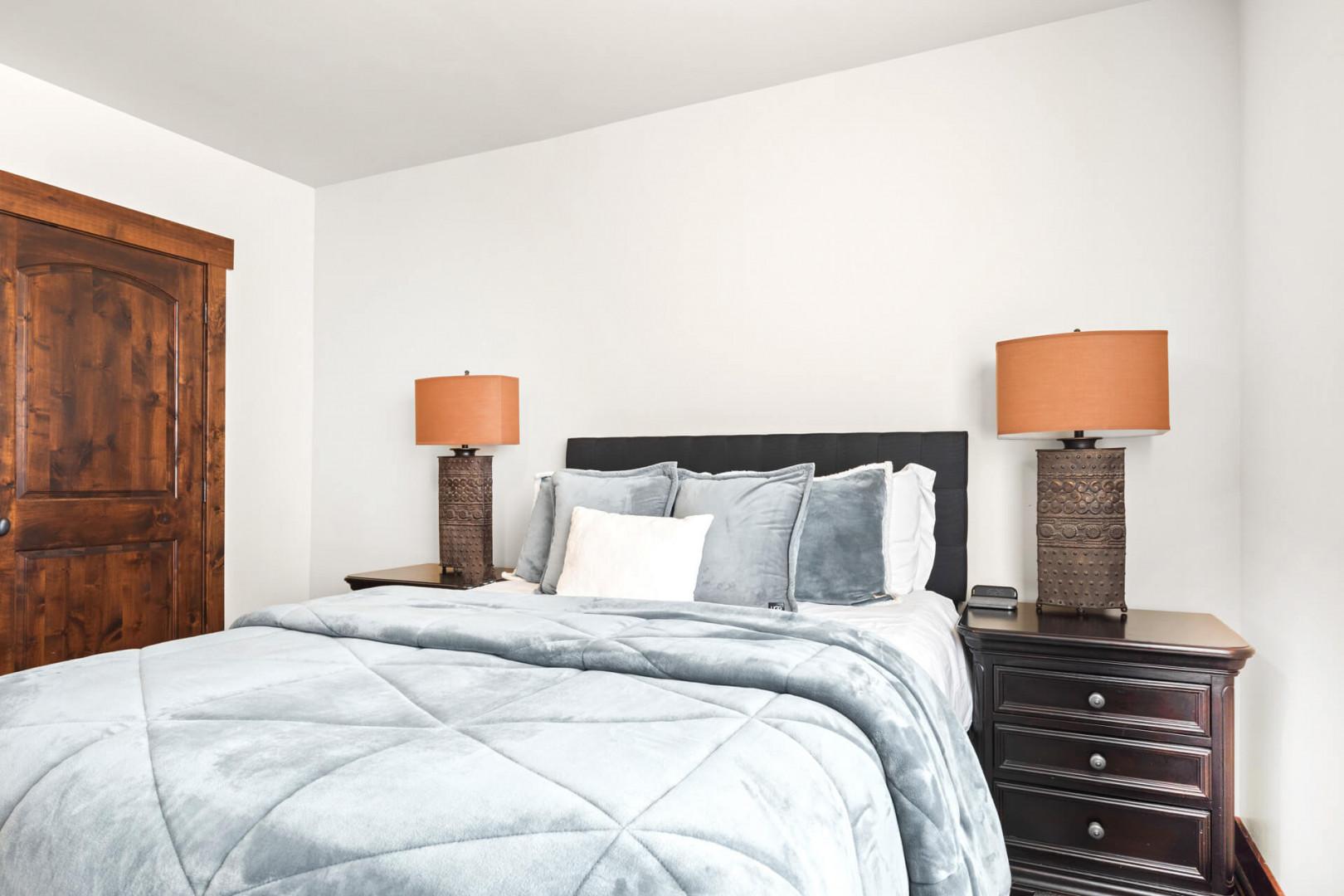 Sink into cloud-soft bedding and unwind in your elegant retreat, where warm lighting creates the perfect ambiance for restful nights.