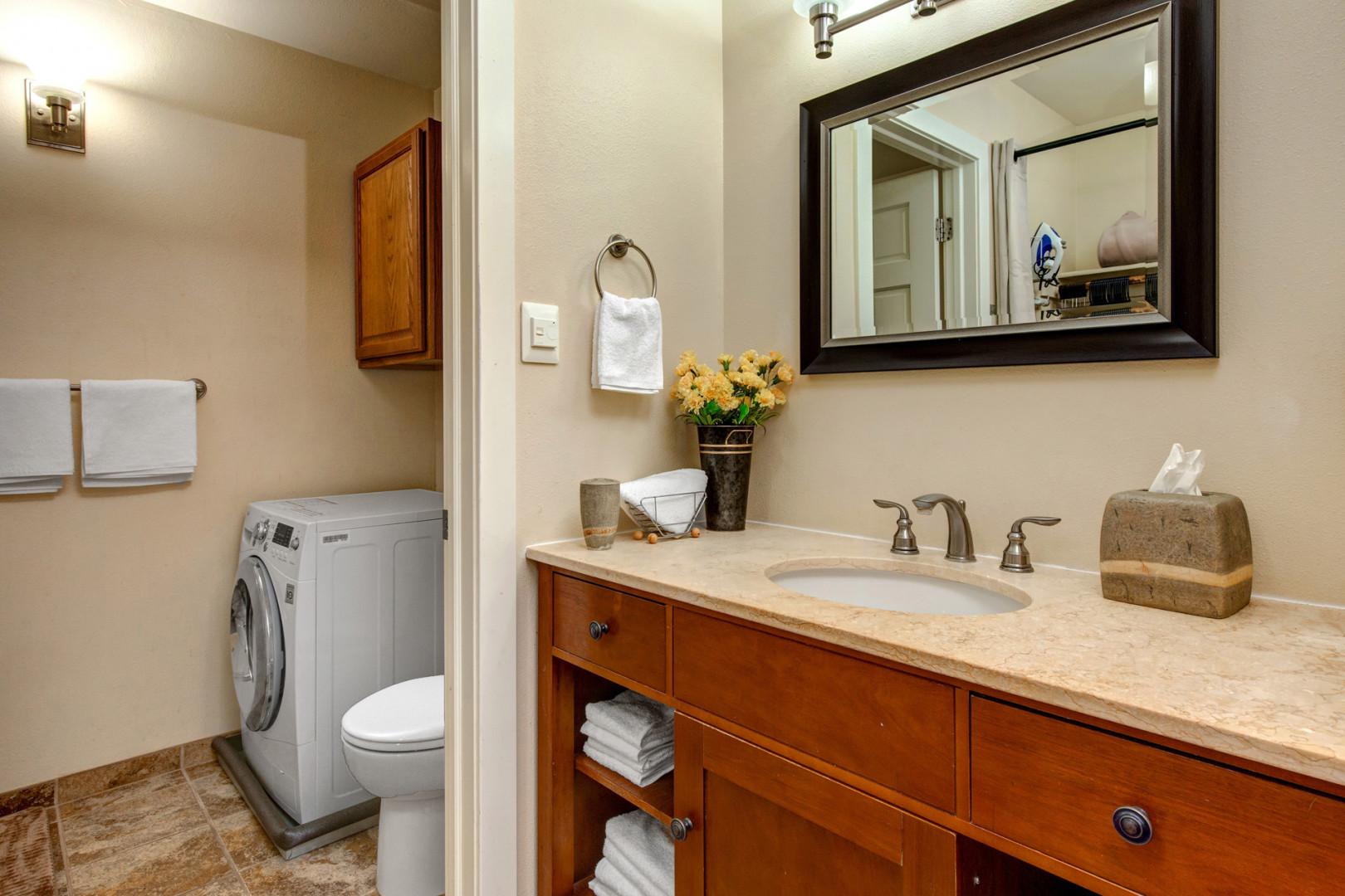 Sleek sink, mirror, toilet, and shower in modern design.