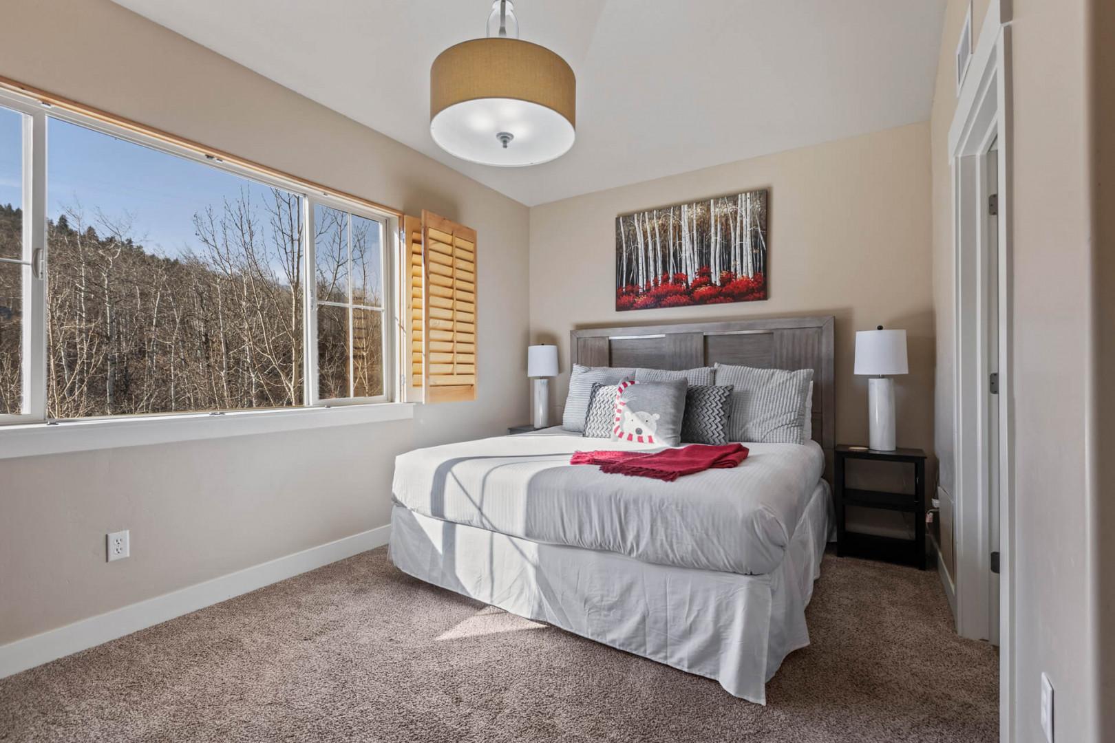 Bear Hollow 1404: Sunlight streaming through window onto cozy bed, inviting relaxation and rest.