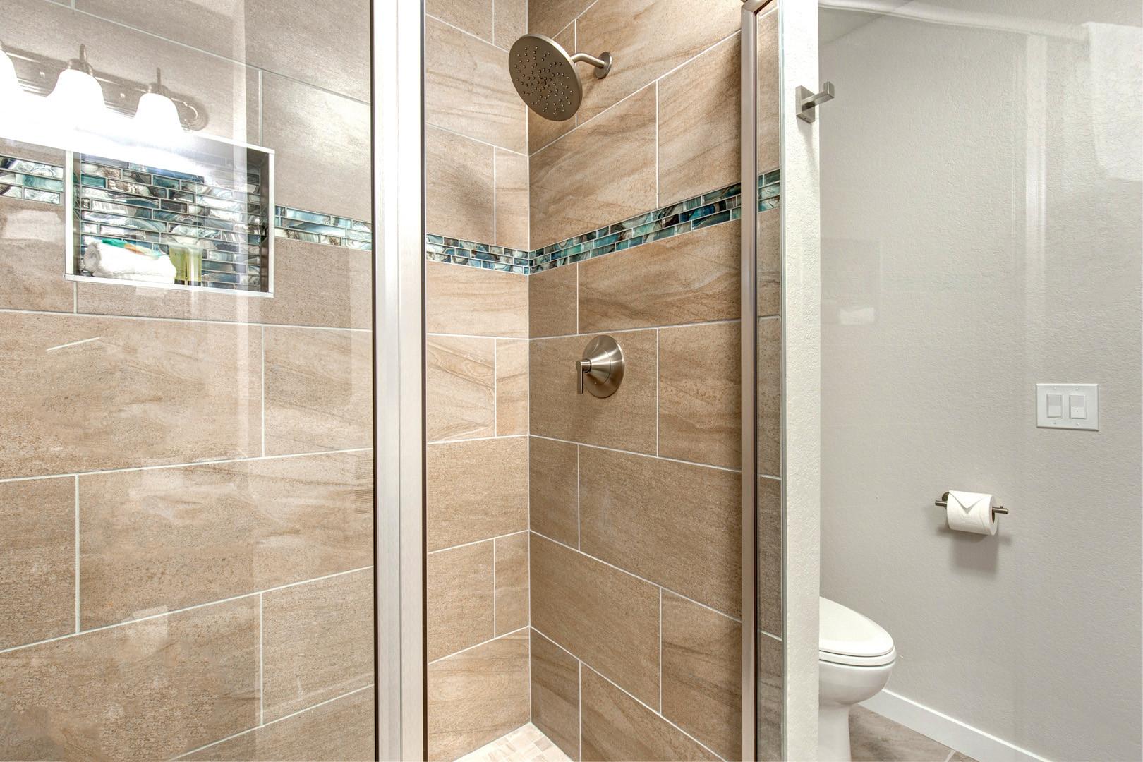 Sleek shower and modern toilet in this stylish space.