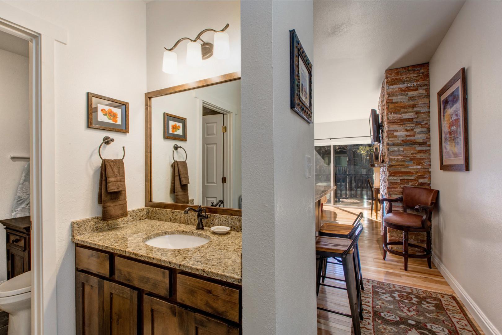 Reflective sink area with a sleek mirror, perfect for morning routines.