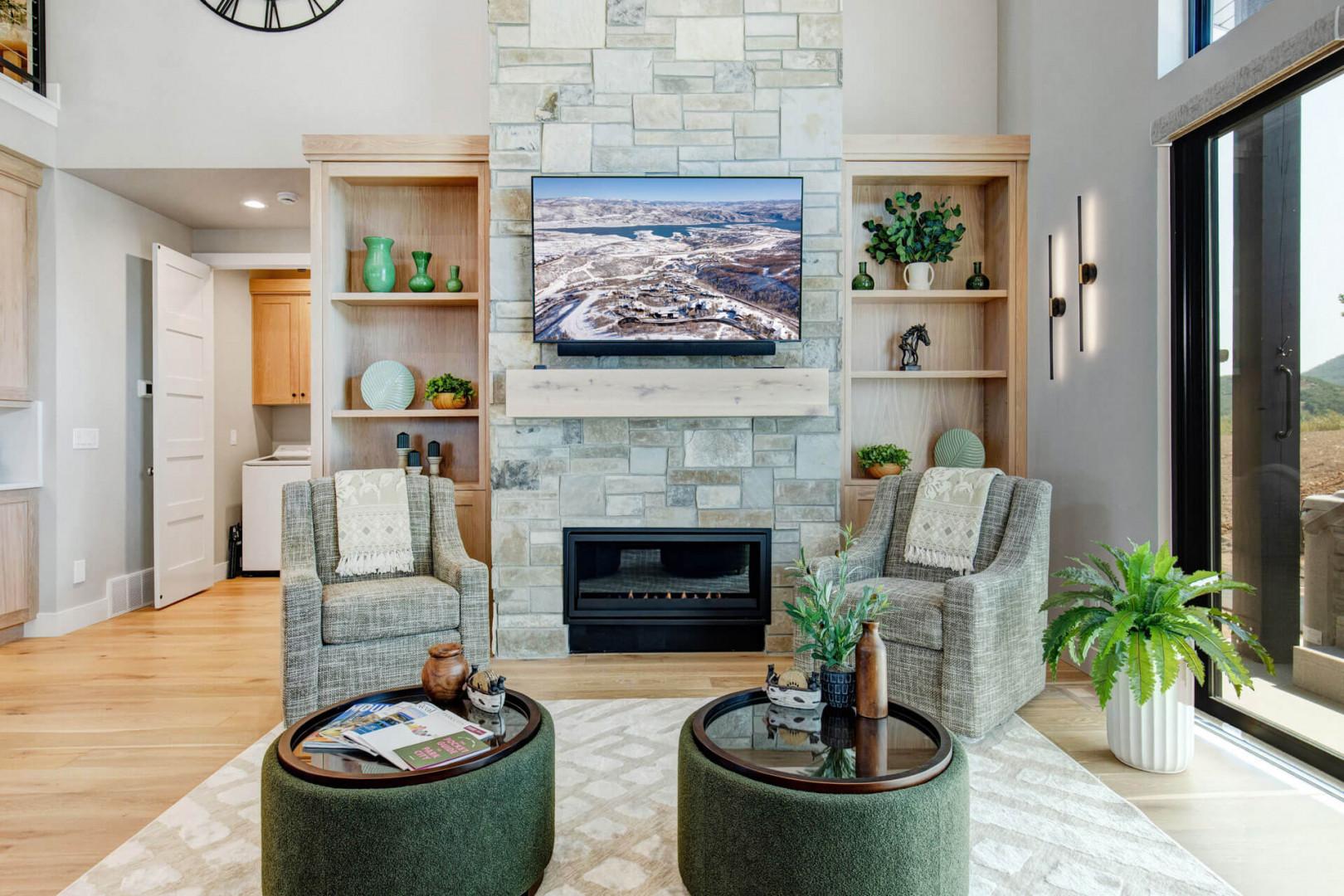 Unwind in your elegant living room, where a cozy fireplace and plush seating invite you to relax. The stone accent wall and built-in shelving add warmth, while natural light streams through the doors.