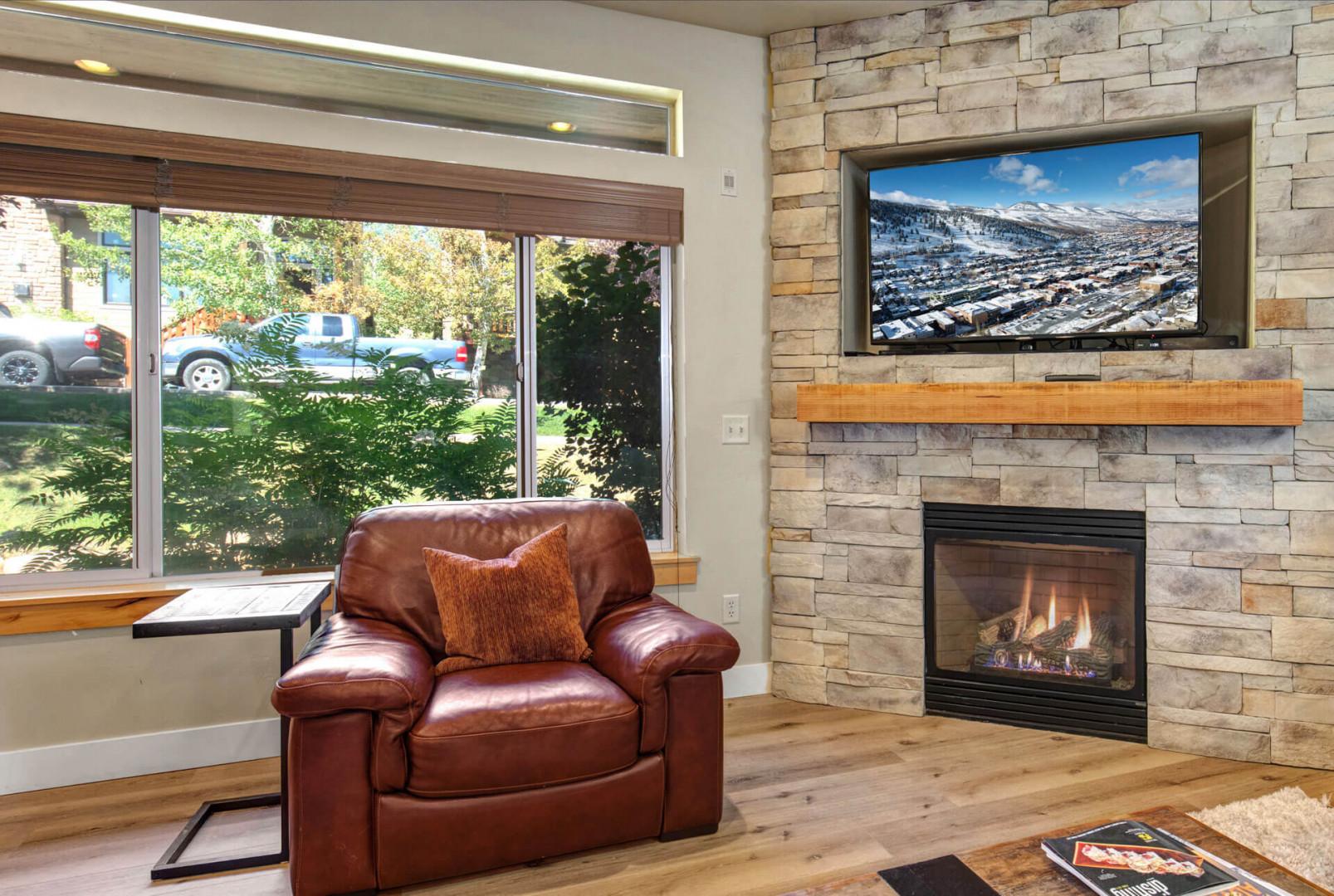 Relax in your cozy leather armchair beside the stone fireplace, watching your favorite shows on the large flat-screen TV.