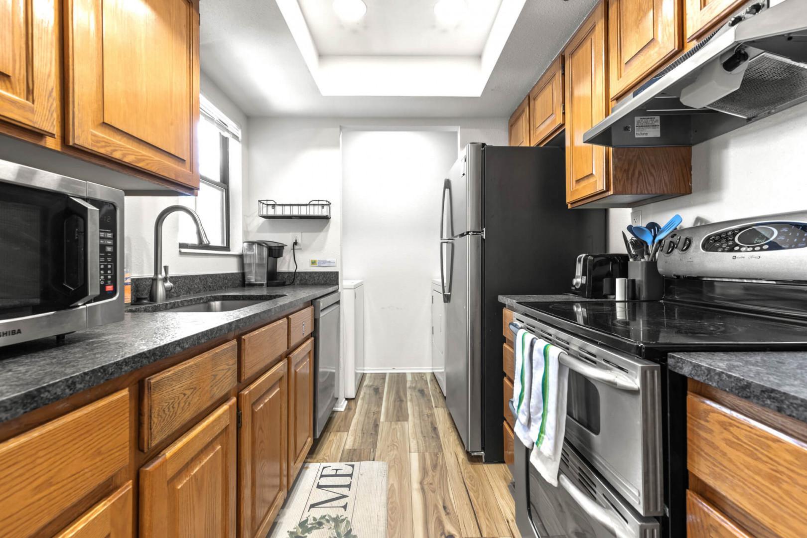 Powderwood 12N: Modern appliances and ample storage in sleek kitchen design.