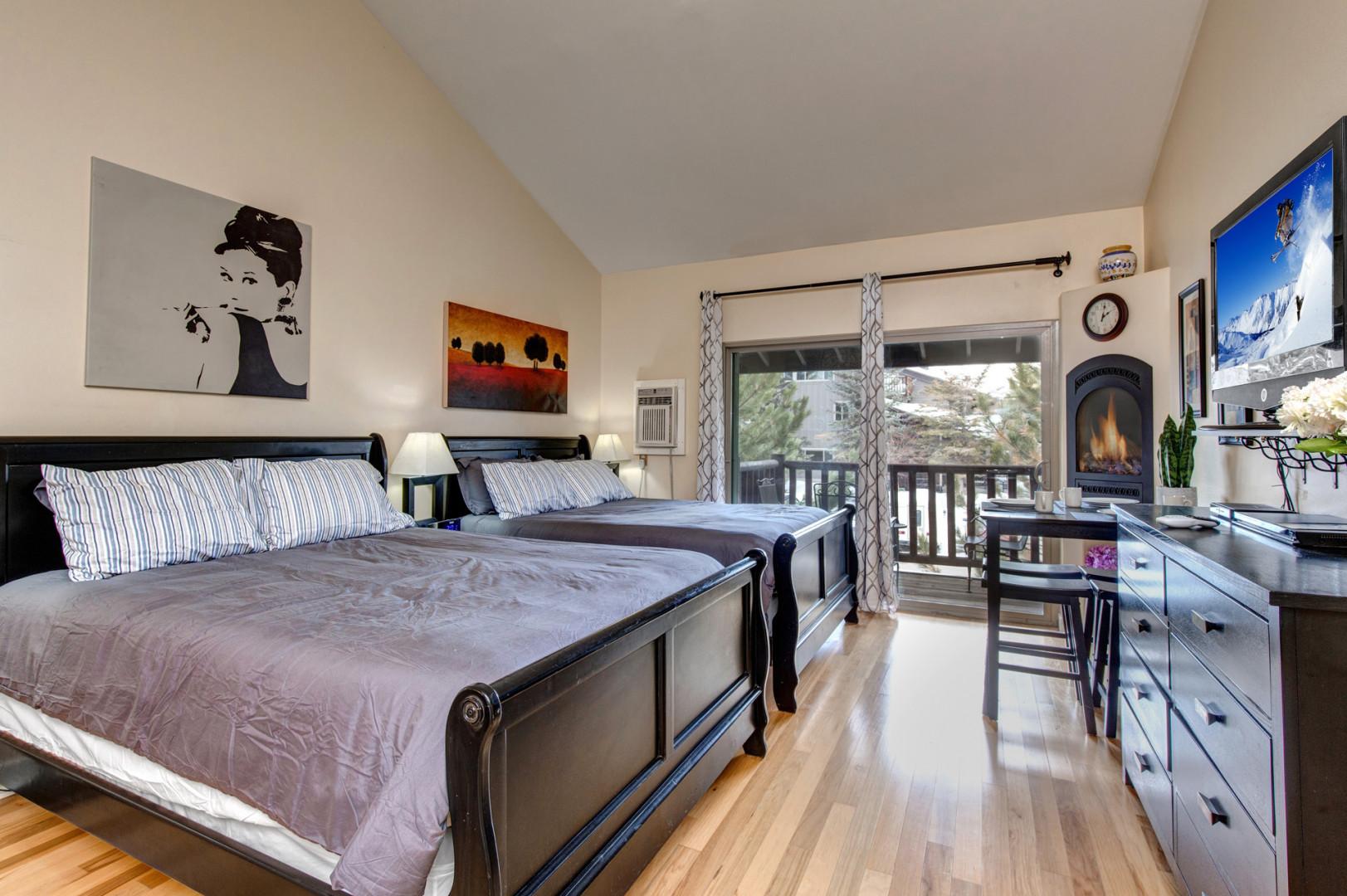 Two Queen Bed Suite: "Cozy setup with patio view, perfect for a relaxing staycation."