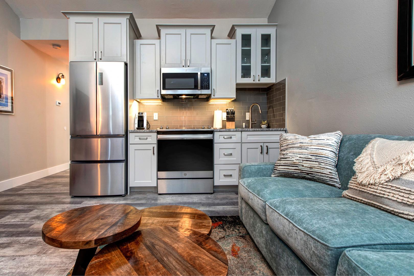 Cozy sofa bed and kitchen with a stylish center table.