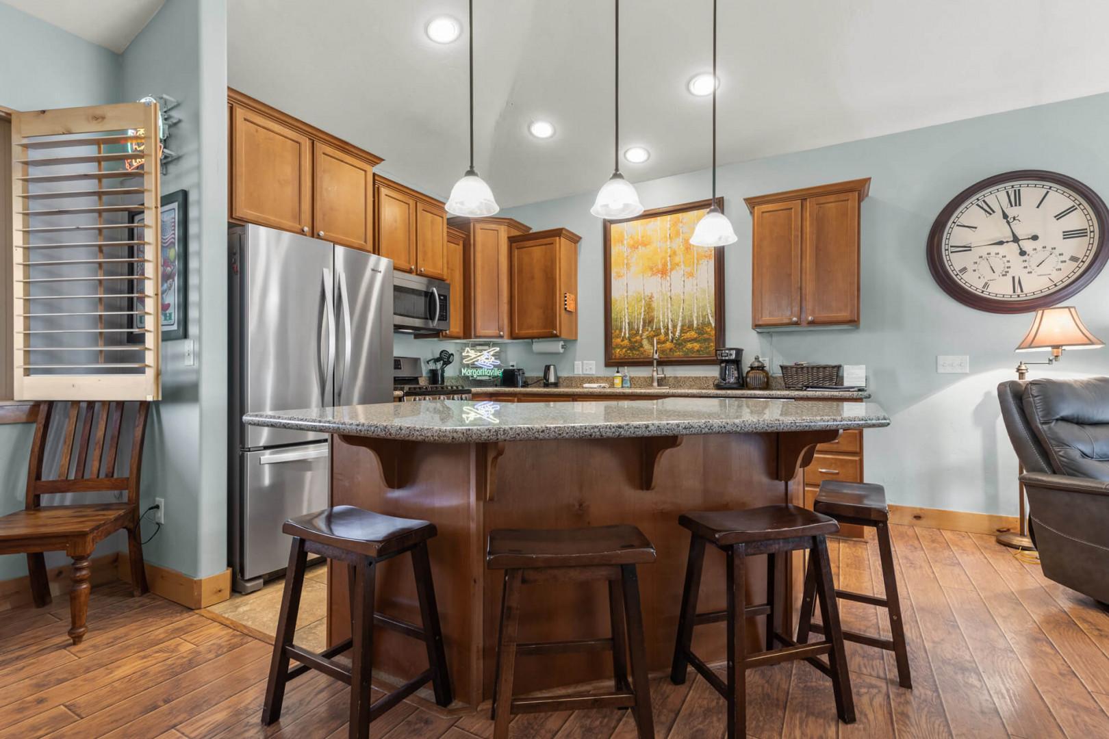 Bear Hollow Lodge 1401: A curved island with bar stool seating leads into the open kitchen. A perfect location for snacks, meals or games.