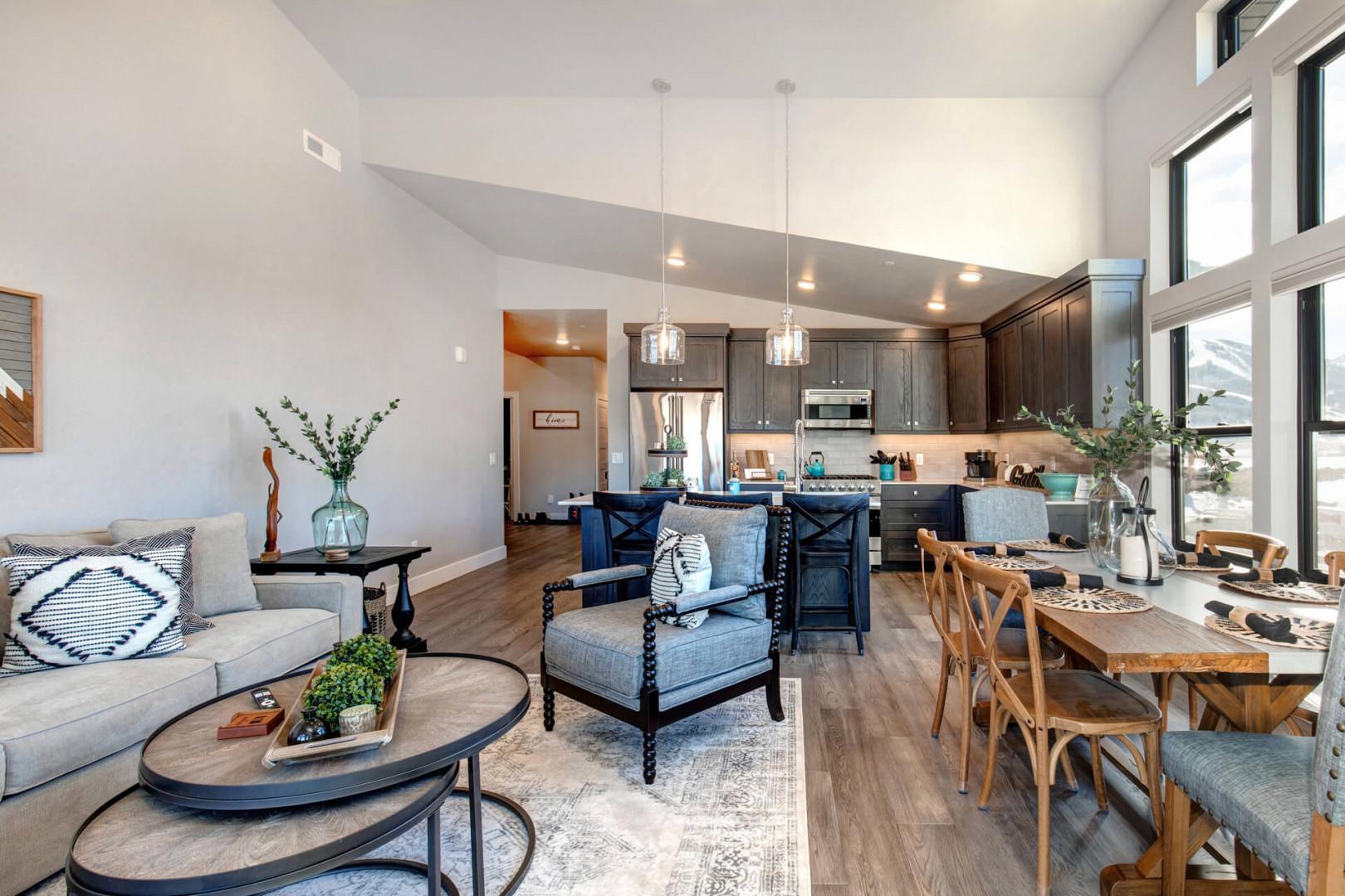 Cozy space with a stylish sofa set, dining table, and kitchen.