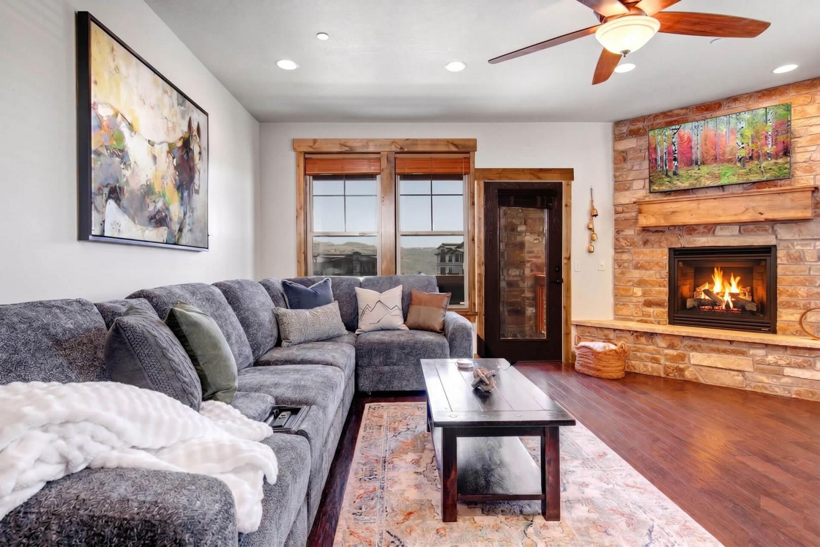 Sink into plush seating by a crackling fire, with warm wood accents and mountain views framing your peaceful retreat.
