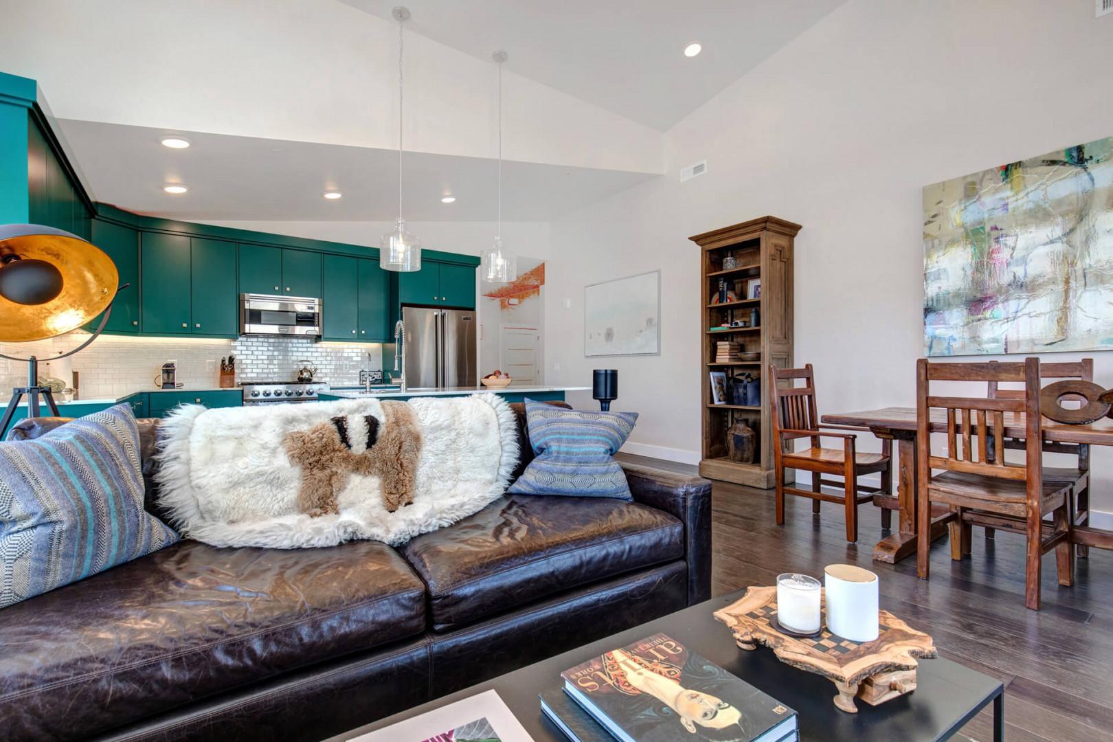 Cozy sofa set with a view of the kitchen in the background.