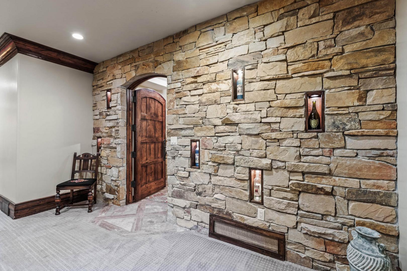 Stone-walled room showcasing an array of displayed liquors.