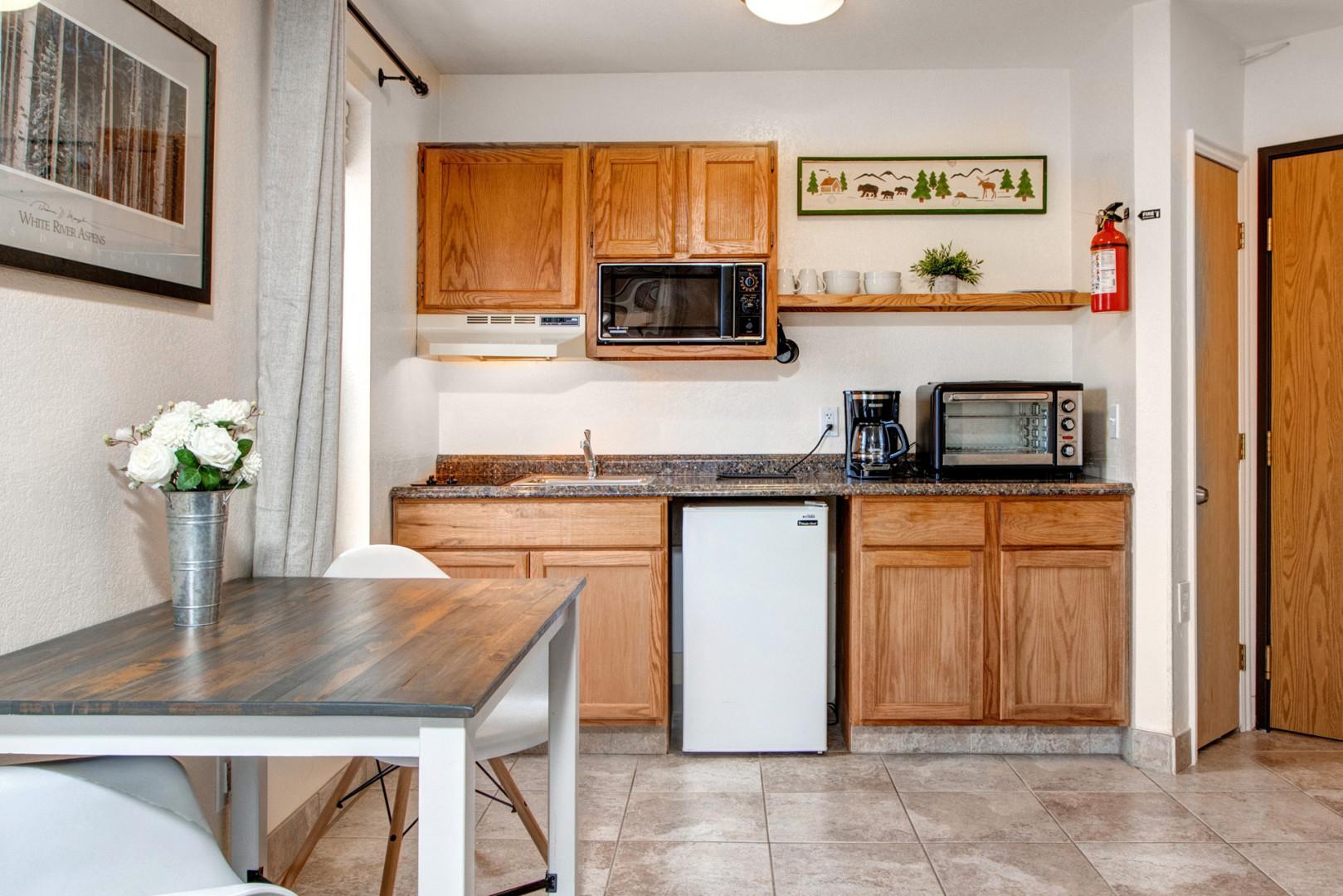 Cozy table for two beside the kitchen, perfect for intimate meals.