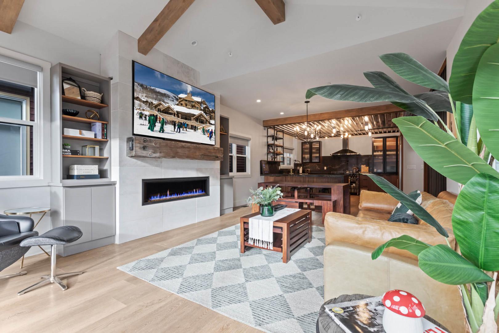 Cozy sofa for three by the gas fireplace and TV.