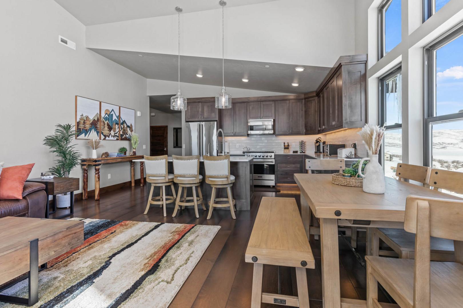 Cozy sofa set, and dining table, with a glimpse of the kitchen.