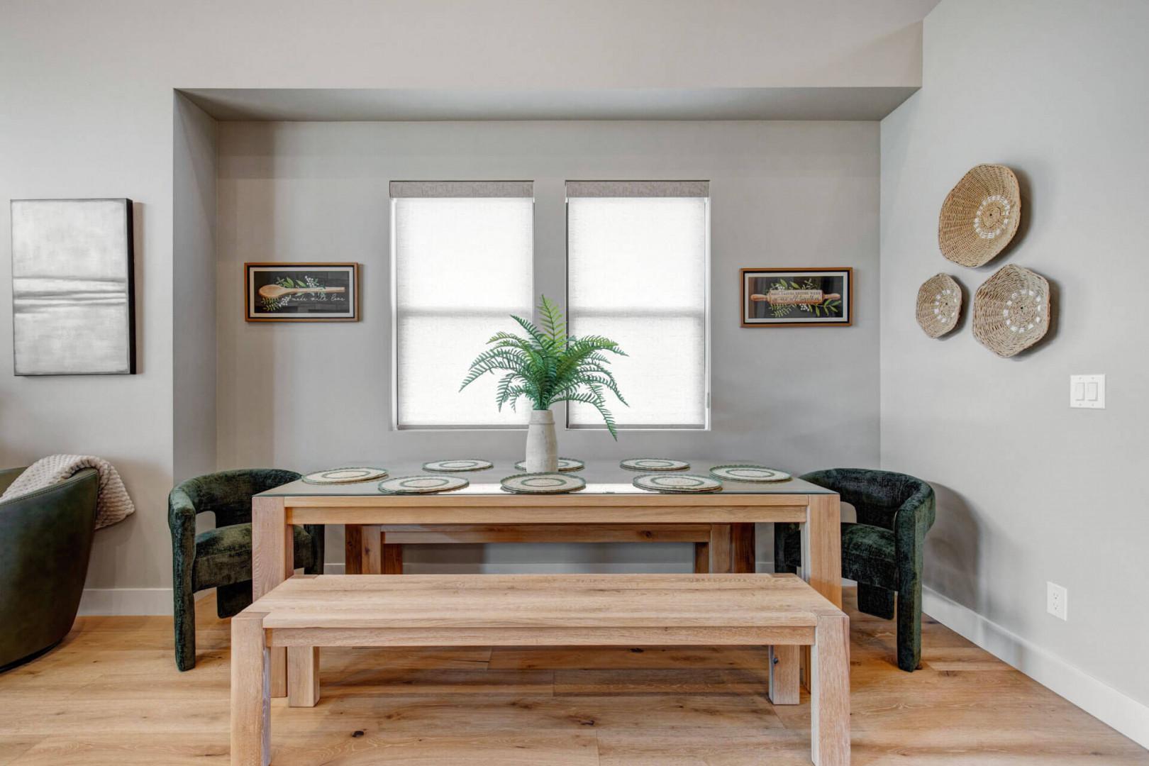 Gather around this inviting dining table where you'll share memorable meals in a bright, thoughtfully designed space filled with natural light and warm wood tones.