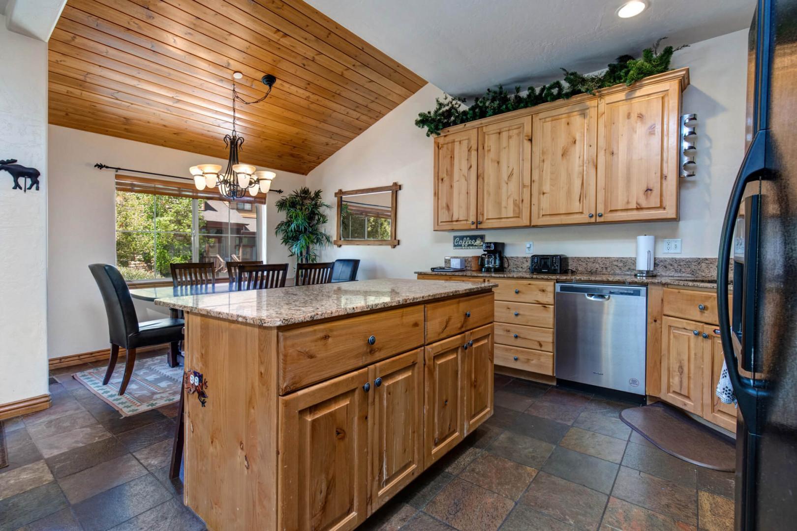 Bear Hollow Lodges 5474: Modern appliances and ample storage in sleek kitchen design.