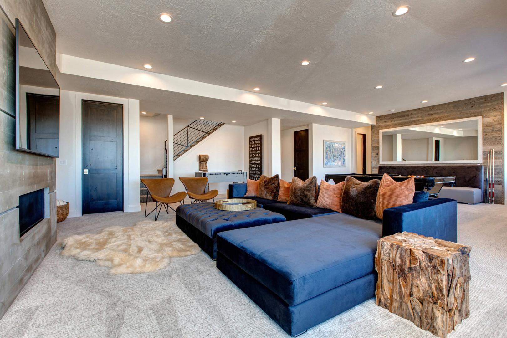 Cozy space with a fireplace, TV, and stylish sofa set.