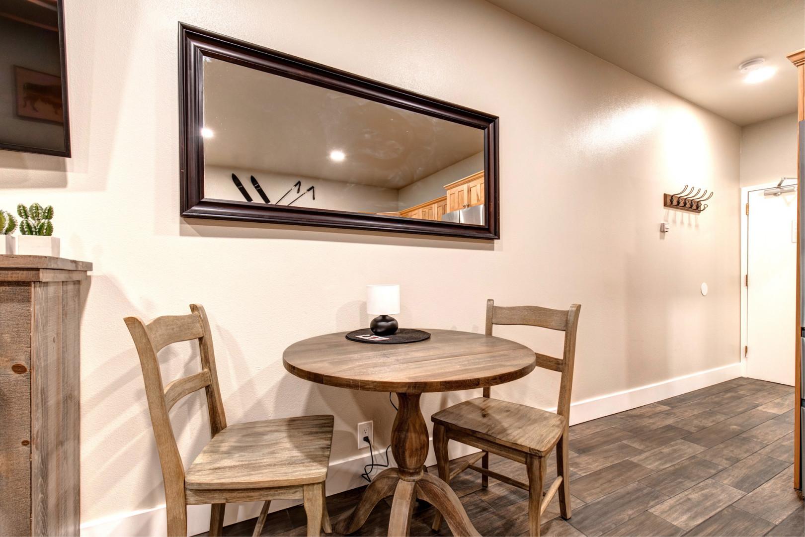 Modern dining table with overhead mirror TV creating a stylish ambiance.