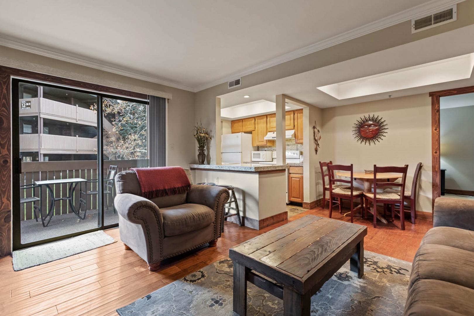 Powderwood 11C: Cozy sofa set, dining table, with a glimpse of the kitchen.