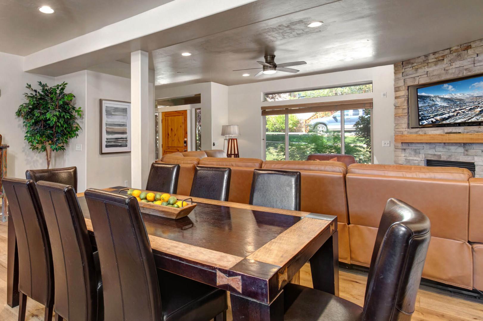 Gather around your spacious dining table for memorable meals, with leather seating and a cozy fireplace creating the perfect atmosphere.