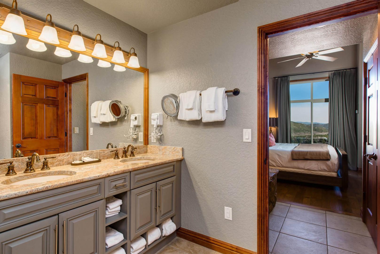 Reflective sink area with a sleek mirror, perfect for morning routines.