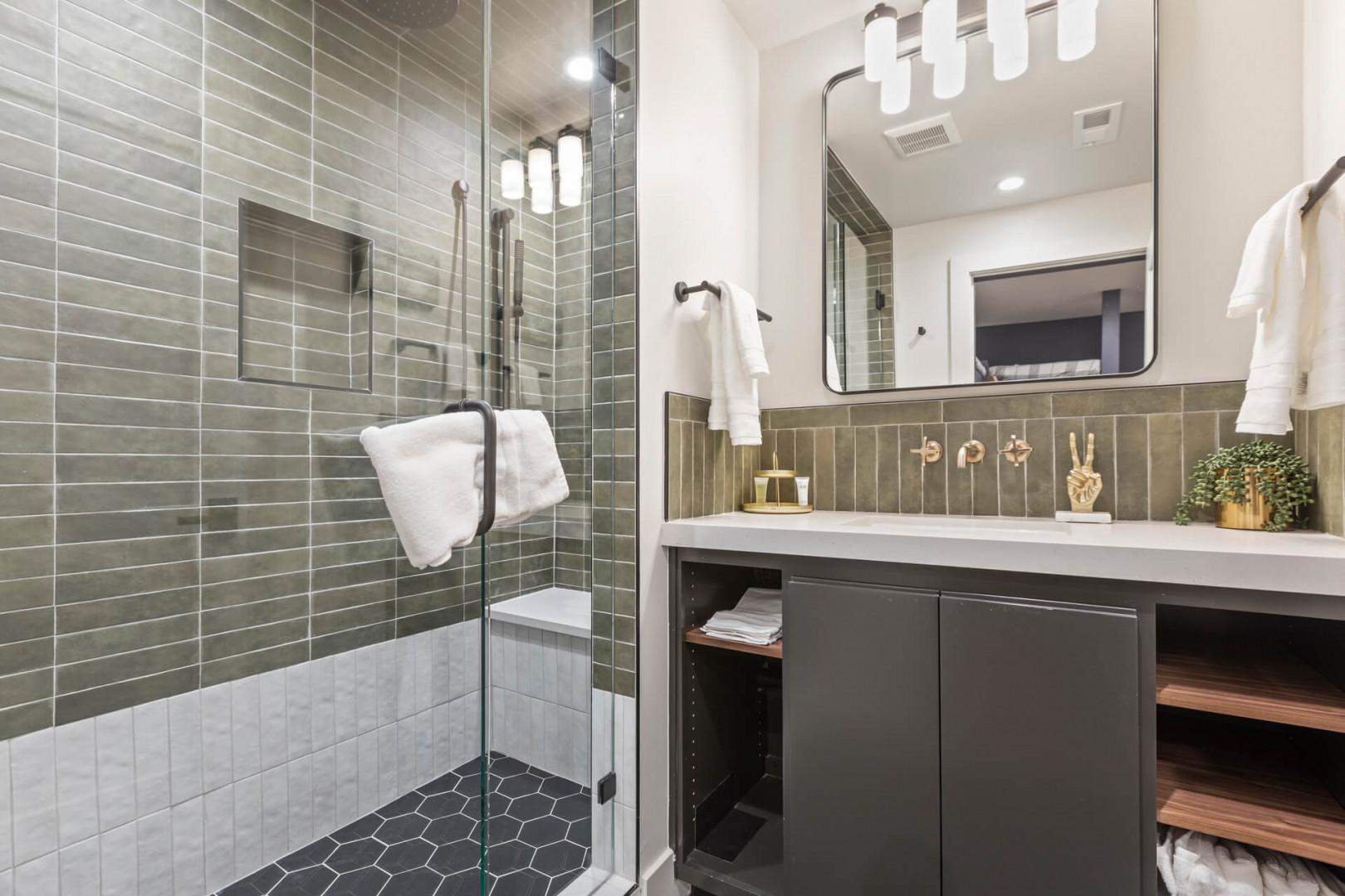 Refreshing oasis with sleek sink and modern shower area.