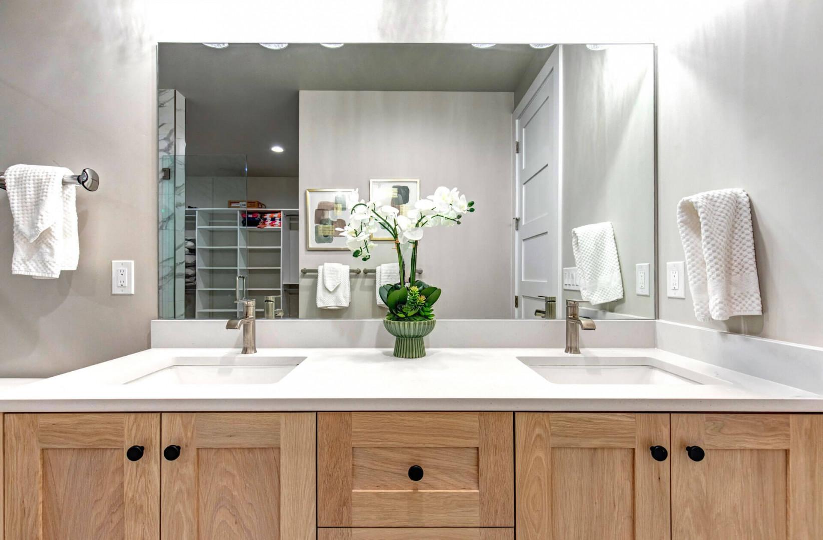 Dual vanities with modern fixtures and warm wood cabinetry offer you a refined retreat to start and end your day.