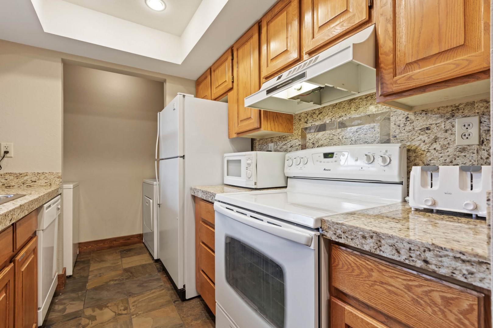 Powderwood 11C: Modern appliances and ample storage in sleek kitchen design.