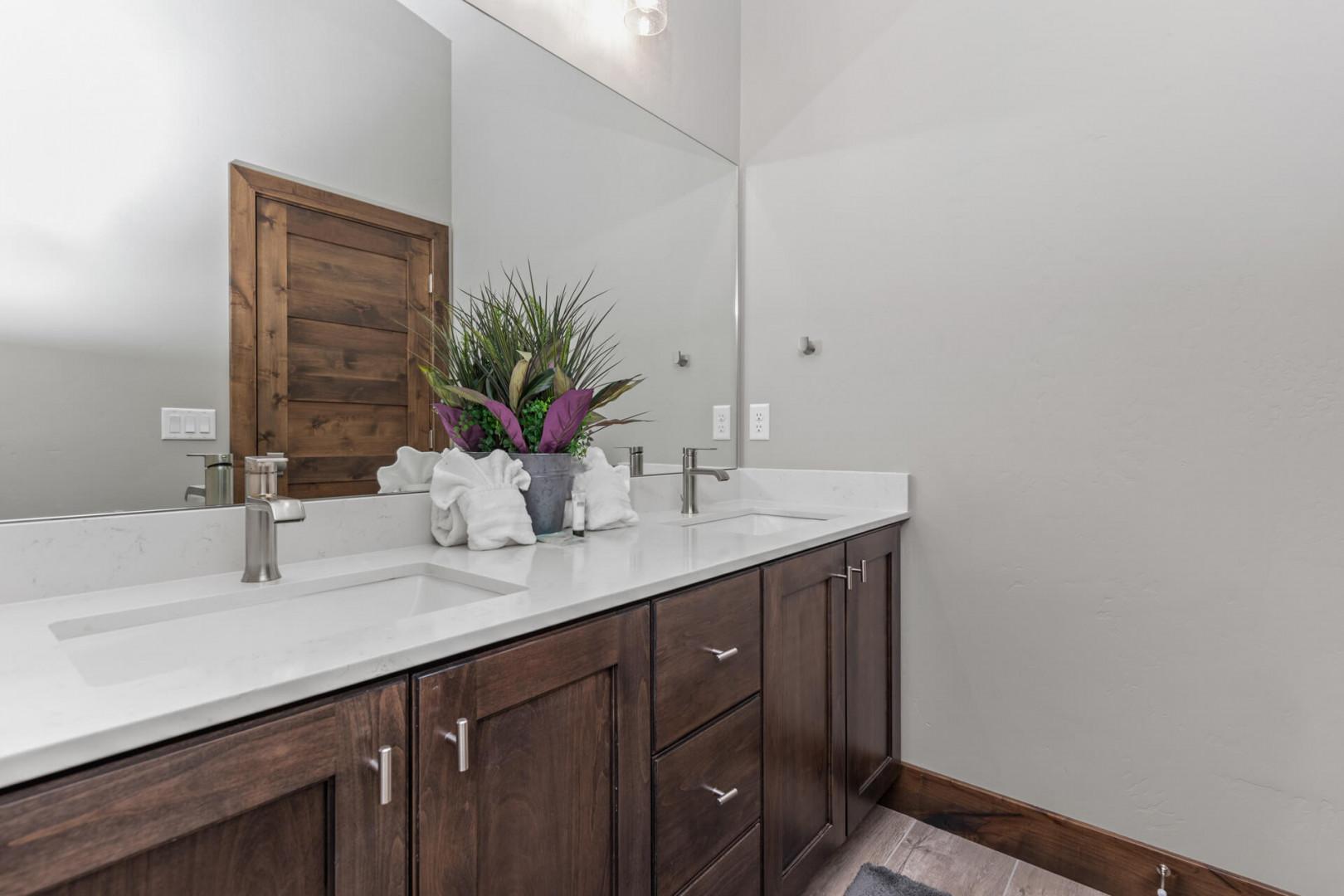 Reflective sink area with a sleek mirror, perfect for morning routines.