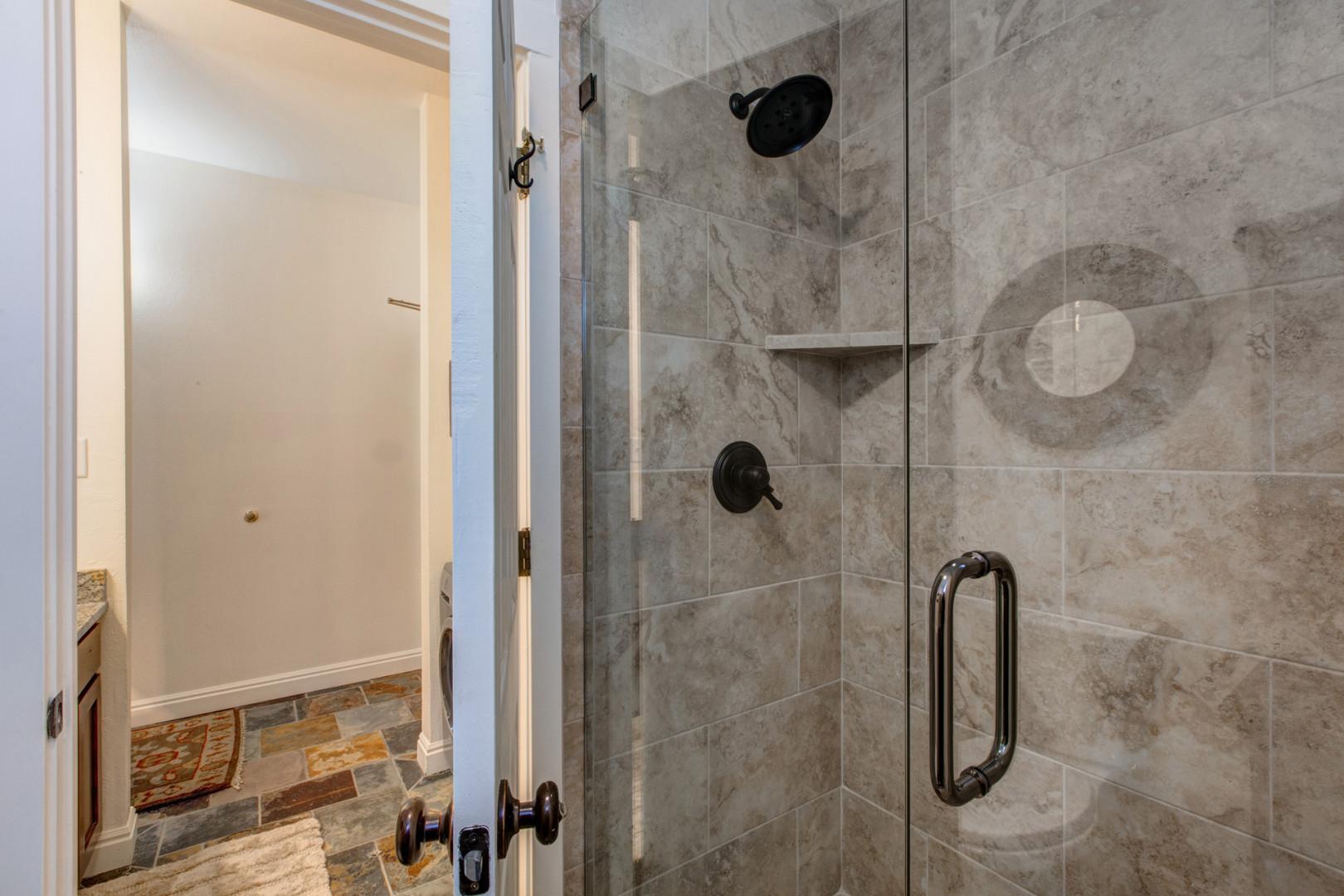 Modern shower with sleek glass enclosure, inviting relaxation.