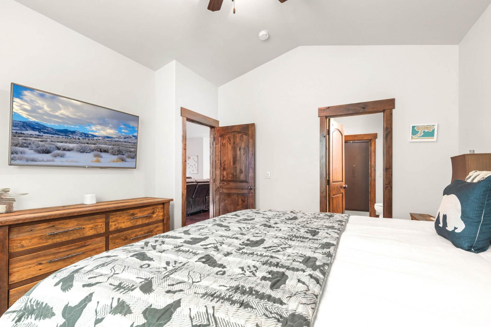 Unwind in your peaceful bedroom with mountain art, rich wood accents, and cozy linens.