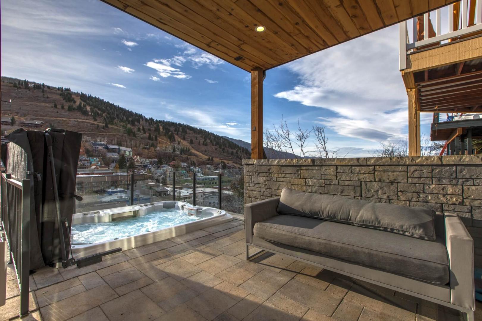 Outdoor Patio: "Serene mountain view from hot tub in charming neighborhood setting.