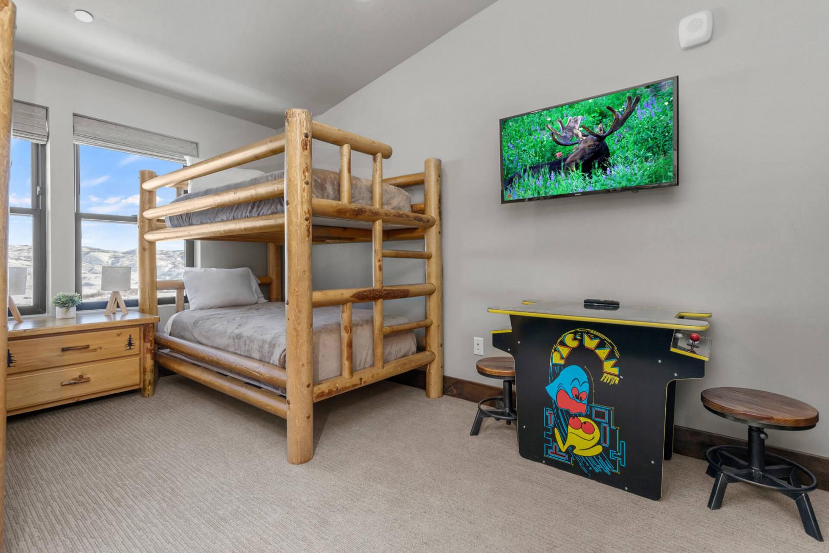 Bunk Bed: "Cozy retreat with arcade games for endless fun and relaxation."