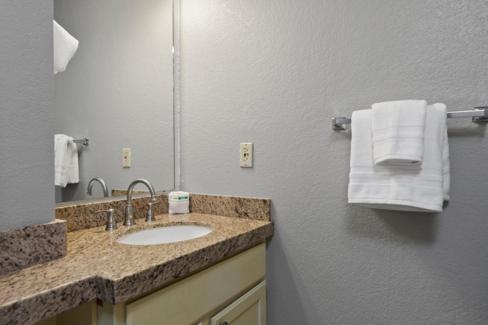 Sleek sink in a serene oasis of cleanliness and comfort.