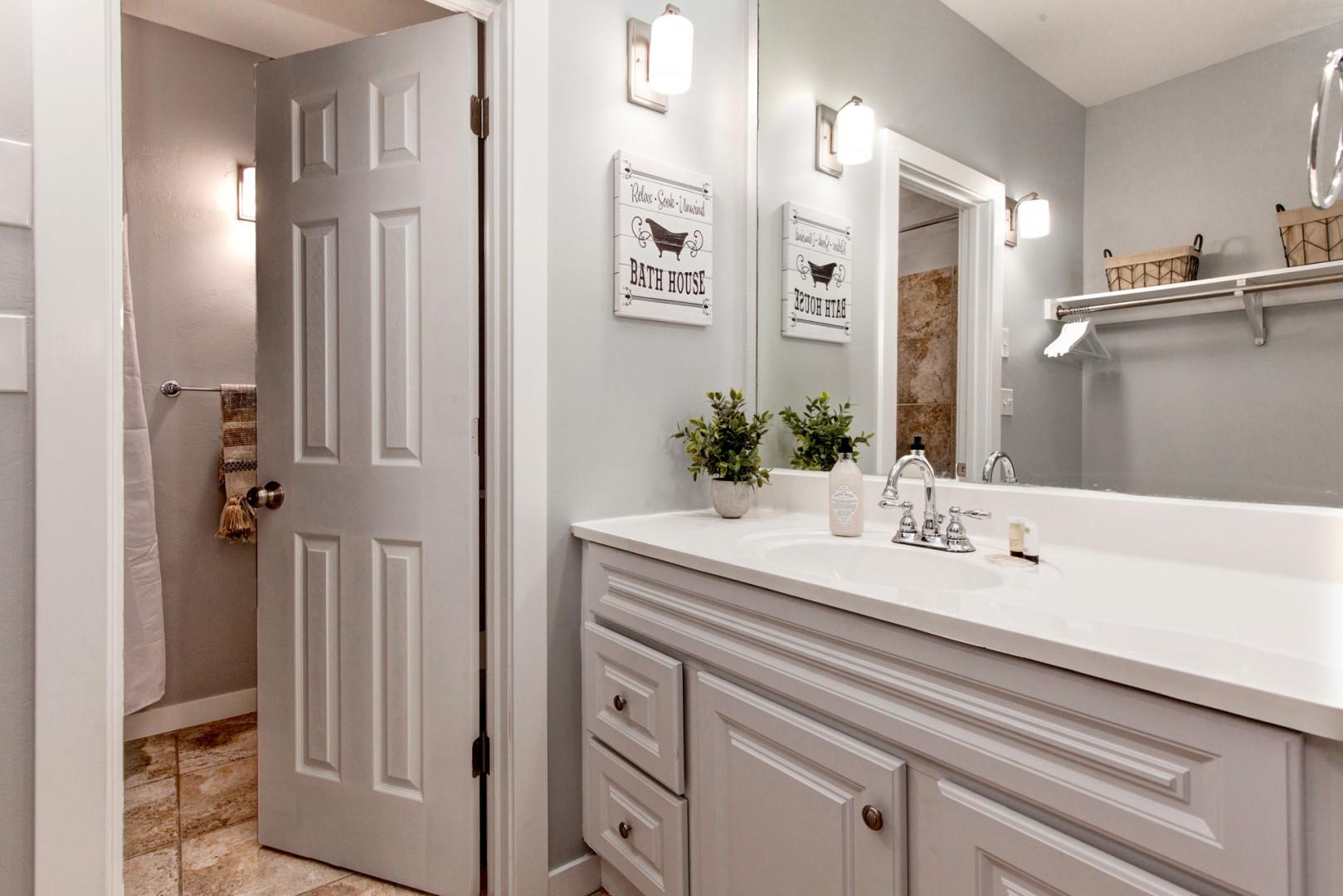 Reflective sink area with a sleek mirror, perfect for morning routines.