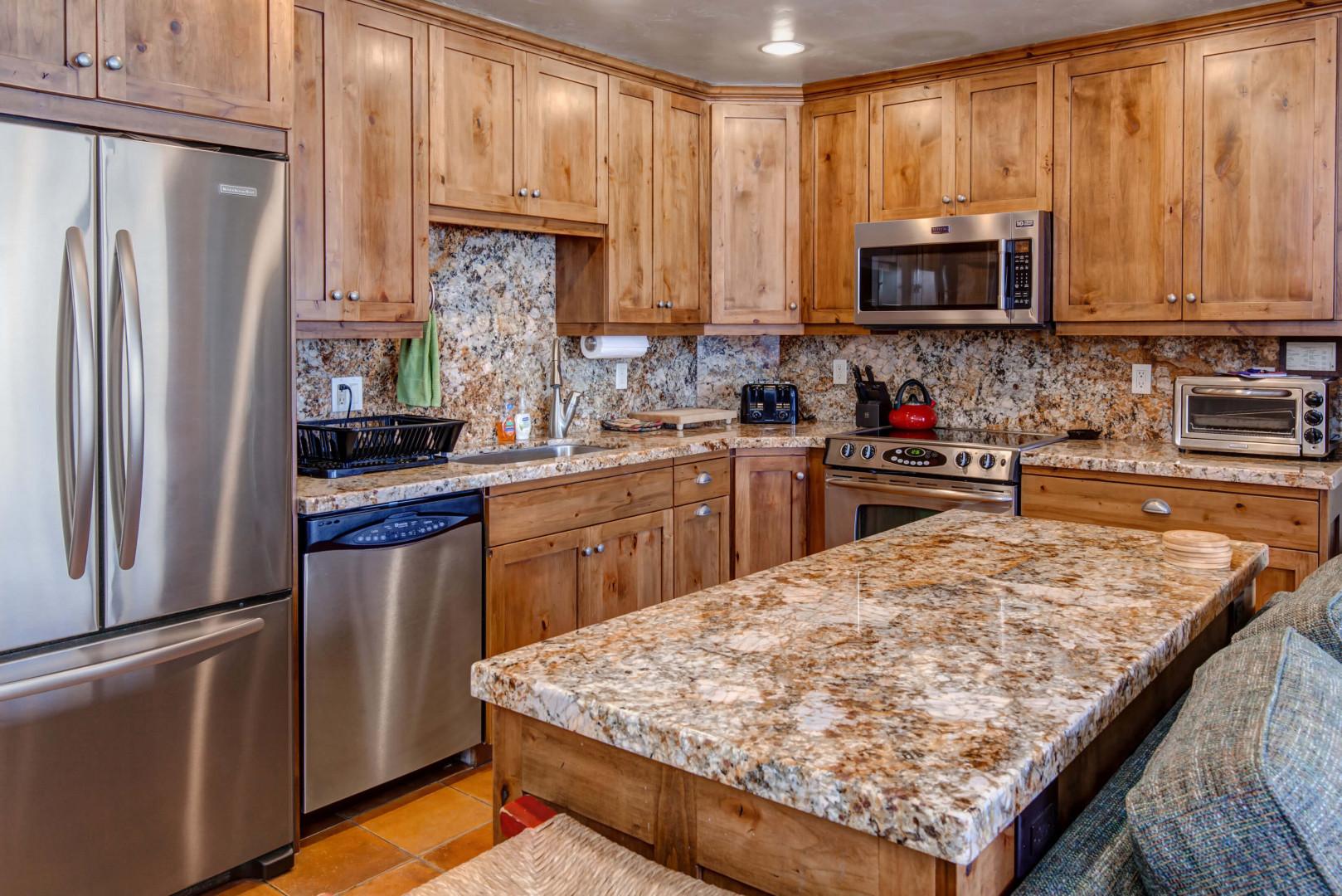 Wood cabinets, kitchen tops, center table - a cook's paradise.